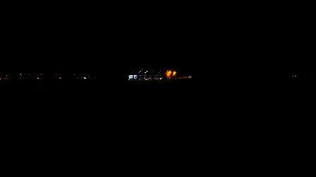 Stal aan de Dronkelaarseweg in Terschuur in de late avond. Door zijn verlichting is de stal van verre zichtbaar in het verder open en donkere landschap